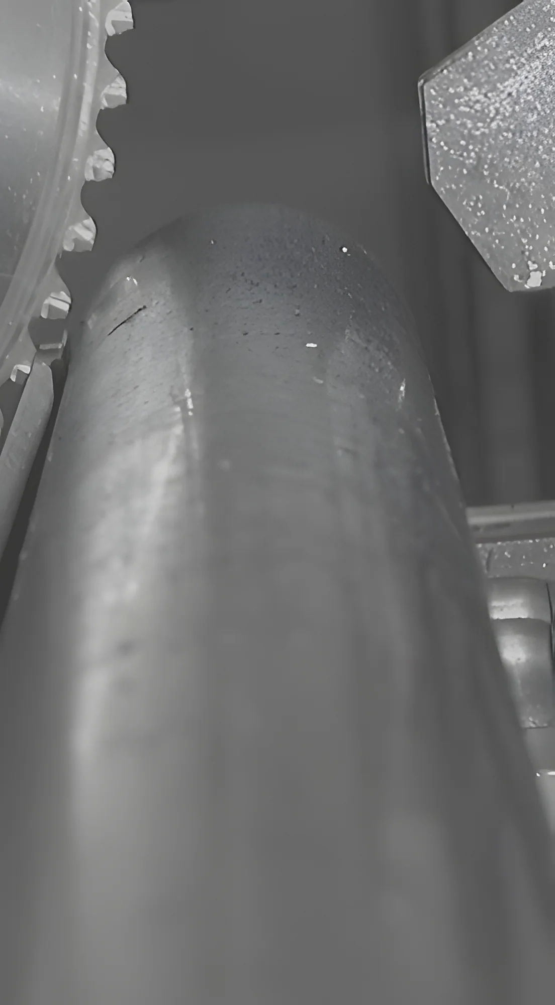 Close up of a cold saw blade and steel bar stock